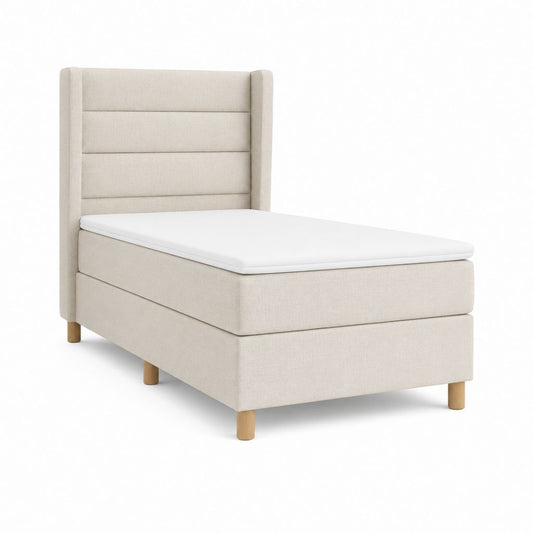Lit simple boxspring rembourré en tissu beige avec tête de lit, matelas et topper, surface de repos 90 × 200 cm